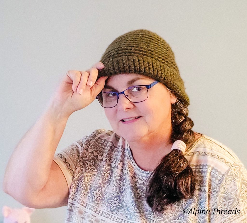 Woman wearing a crocheted green beanie