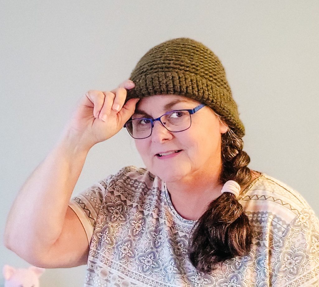 Woman wearing a crocheted green hat