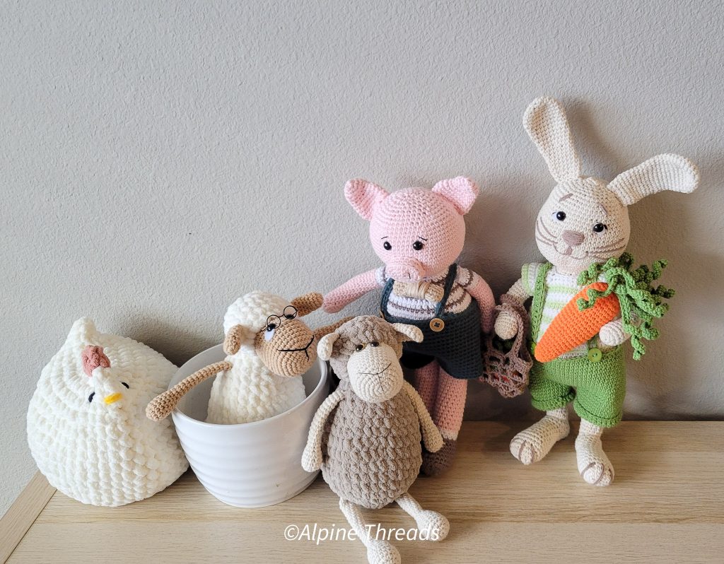Group of amigurumi animals sitting on a shelf