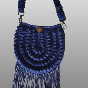 Navy blue crocheted crossbody purse with fringe.